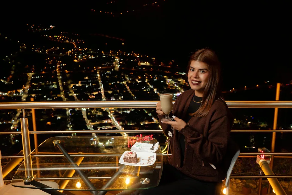 Una pausa de café con la ciudad iluminada.